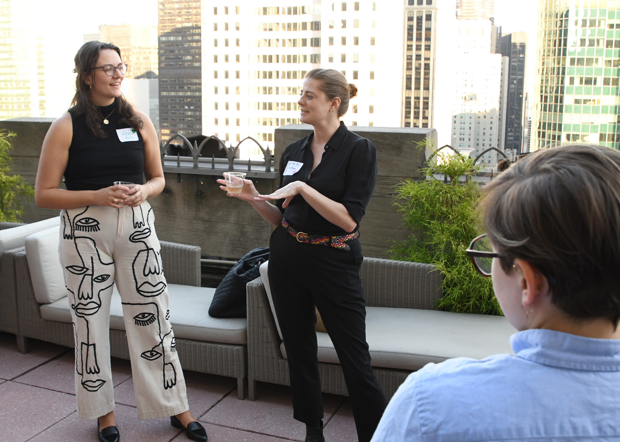 Two women speaking to a group of people
